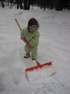 Mira shoveling the driveway